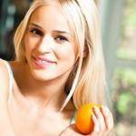 Young smiling woman with orange